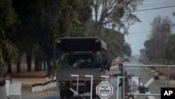 A truck with soldiers and sniffer dogs enter Thai army's 22nd Ammunition Battalion in Surathampitak Military Camp, where a Thai soldier turned mass shooter stole a cache of weapons in Nakhon Ratchasima, Feb. 10, 2020. 