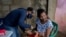 A child is vaccinated in Barcelona, Anzoategui State, Venezuela, March 16, 2021. In Venezuela there are people who had malaria up to 20 times.
