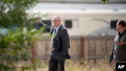 Fremont County, Colo., coroner Randy Keller meets with fellow authorities outside a closed funeral home Oct. 6, 2023, in Penrose, Colo.