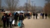 FILE - Migrants walk in Edirne at the Turkish-Greek border, March 9, 2020.