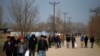 Migrants walk in Edirne at the Turkish-Greek border, March 9, 2020. 