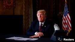 U.S. President Donald Trump takes questions from the media after speaking via teleconference with troops from Mar-a-Lago estate in Palm Beach, Florida, Nov. 22, 2018. 