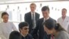 Blind activist Chen Guangcheng (C) speaks with his wife Yuan Weijing (2nd R) and children as U.S. ambassador to China Gary Locke (facing camera, 3rd R) and U.S. Assistant Secretary of State for East Asian and Pacific Affairs Kurt Campbell (facing camera, 