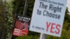 Anti-abortion-rights and pro-abortion-rights posters are seen outside the home of Amy Callahan, who received a fatal fetal diagnosis at 12 weeks into her pregnancy and traveled to Liverpool for a termination in Dublin, Ireland, May 7, 2018. Ireland will vote this month on whether to retain a constitutional ban on abortions or repeal it and make parliament responsible for creating abortion laws.