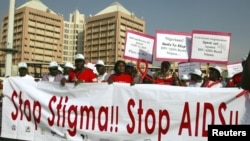 People holding banners march to campaign for increased aids awareness in the streets of Nigeria's capital Abuja December 1, 2006 on World Aids Day.
