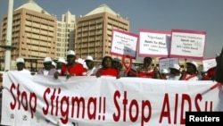 People holding banners march to campaign for increased aids awareness in the streets of Nigeria's capital Abuja, December 1, 2006, on World Aids Day.