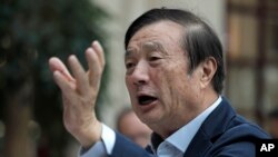 FILE - Ren Zhengfei, founder and CEO of Huawei, gestures during a meeting with reporters in Shenzhen city, south China's Guangdong province, Jan. 15, 2019. 