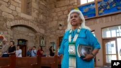 Mescalero Apache Tribe elder Donalyn Torres arrives to attend mass at the St. Joseph Apache Mission church in Mescalero, New Mexico, July 14, 2024.