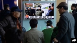 People watch a TV news program showing North Korean leader Kim Jong Un with superimposed letters that read: "North Korea has made nuclear warheads small enough to fit on ballistic missiles" at Seoul Railway Station in Seoul, South Korea, Wednesday, March 