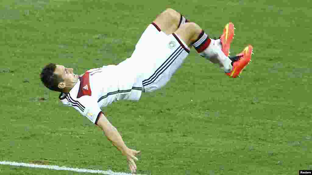 Germany's Miroslav Klose does a flip as he celebrates scoring a goal against Ghana at the Castelao arena in Fortaleza June 21, 2014.