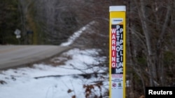 FILE - A signpost sits near Enbridge’s Mackinaw facility, servicing the company’s existing underwater Line 5 pipeline and its planned replacement tunnel under Lake Michigan, in Mackinaw City, Michigan, Feb. 25, 2024.