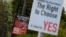 Anti-abortion-rights and pro-abortion-rights posters are seen outside the home of Amy Callahan, who received a fatal fetal diagnosis at 12 weeks into her pregnancy and traveled to Liverpool for a termination in Dublin, Ireland, May 7, 2018. Ireland will vote this month on whether to retain a constitutional ban on abortions or repeal it and make parliament responsible for creating abortion laws.