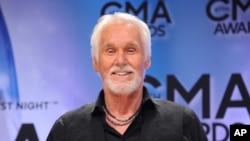 FILE - In this Nov. 6, 2013 file photo, Kenny Rogers, winner of the Willie Nelson lifetime achievement award, poses backstage at the 47th annual CMA Awards in Nashville, Tenn. Rogers said he is retiring from touring and will do one last worldwide farewel tour after five decades on the road.
