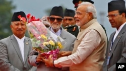 Indian Prime Minister Narendra Modi, second right, receives flowers from his Nepalese counterpart Sushil Koirala, after he arrived at the Tribhuwan International Airport in Katmandu, Nepal, Aug. 3, 2014.