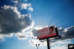 FILE - A billboard advertising treatment for opioid addition stands in Dickson, Tennessee, June 7, 2017.