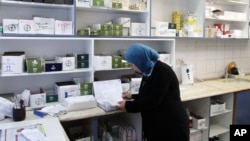 A pharmacist works in the Ramallah Hospital.