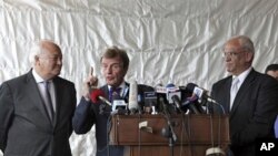 French Foreign Minister Bernard Kouchner, center, speaks during a joint press conference with Spanish Foreign Minister Miguel Angel Moratinos, left, and Palestinian negotiator Saeb Erekat, right, after their meeting with the Palestinian President Mahmoud 