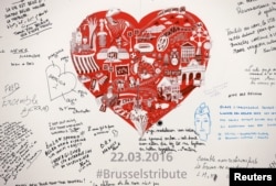 Messages are seen on a memorial for victims at Maelbeek metro station in Brussels, Belgium, April 25, 2016.