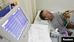FILE - A stroke patient undergoes an electrocardiogram at Juntendo University Hospital in Tokyo. Scientists have found that a neurotoxin secreted by a deadly Australian spider contains a molecule that stalls the effects a stroke has on the brain.