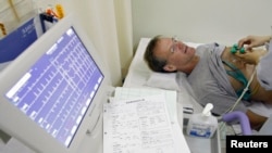 FILE - A stroke patient undergoes an electrocardiogram while recovering at Juntendo University Hospital in Tokyo. 