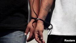 Suspected members of the 18th Street gang are presented to the media after they were arrested in a raid in San Salvador, El Salvador, Aug. 19, 2015.
