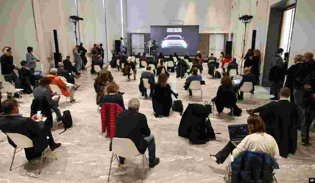 People sit a recommended distance apart from each other during the presentation of the new FIAT 500 electric n Milan, Italy.