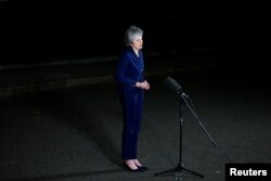 Britain's Prime Minister Theresa May speaks outside 10 Downing Street after a confidence vote by Conservative Party Members of Parliament, in London, Dec. 12, 2018.