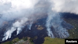 Lava approaches Puna Geothermal Venture, bottom left, in the Leilani Estates near Pahoa, Hawaii, U.S., May 28, 2018. 