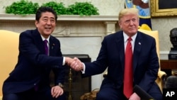 President Donald Trump meets with Japanese Prime Minister Shinzo Abe in the Oval Office of the White House in Washington, June 7, 2018.