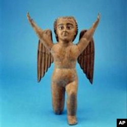 This cherub from the museum’s collection was fashioned of painted wood and glass eyes in the mid-1700s, after Spanish Catholics had introduced the concept of angels.