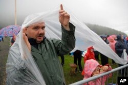 People wait for Pope Francis to celebrate Mass at the Marian shrine, in Sumuleu Ciuc, Romania, June 1, 2019.
