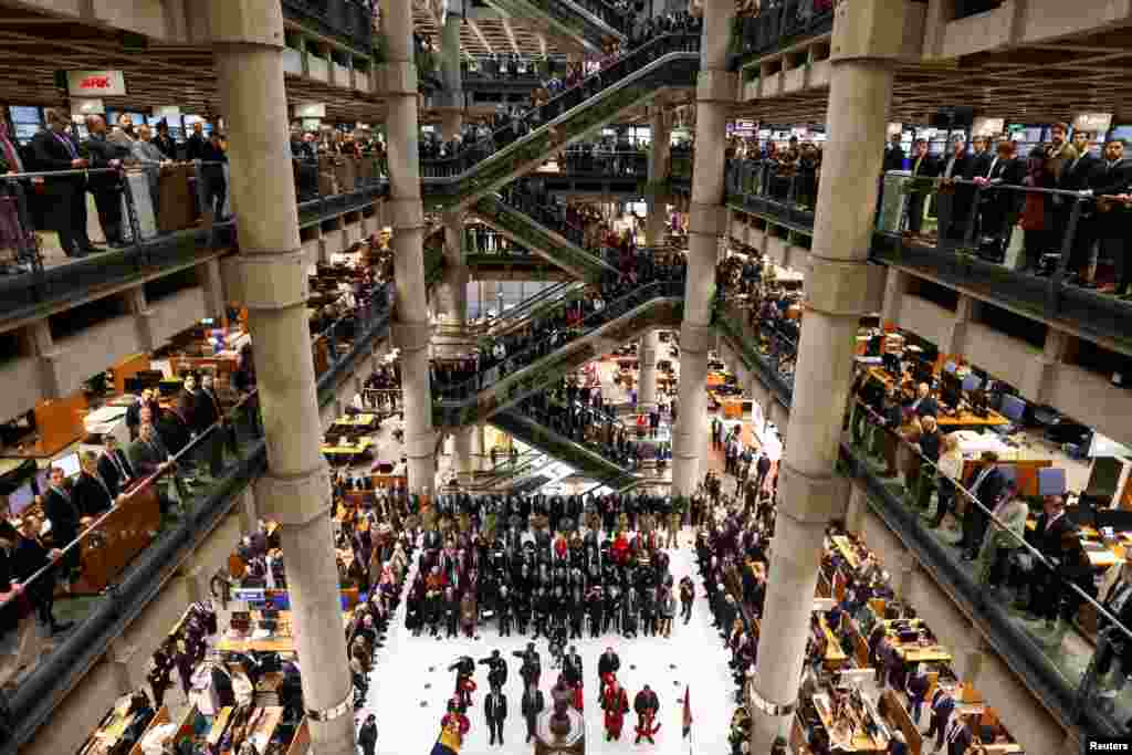 Staff members attend a Remembrance Service at the Lloyd&#39;s building in the City of London, Britain.
