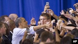 President Barack Obama reaches out to students and parents at Washington-Lee High School in Arlington, Virginia, May 4, 2012. 