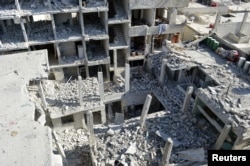 View of buildings damaged by what activists said were missiles fired by a Syrian Air Force fighter jet loyal to President Bashar al-Assad at Jessreen area in Ghouta, east of Damascus, December 2, 2012.