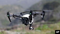 FILE - The Inspire 1, a drone manufactured by DJI, is flown in Davenport, Calif., March 10, 2015.