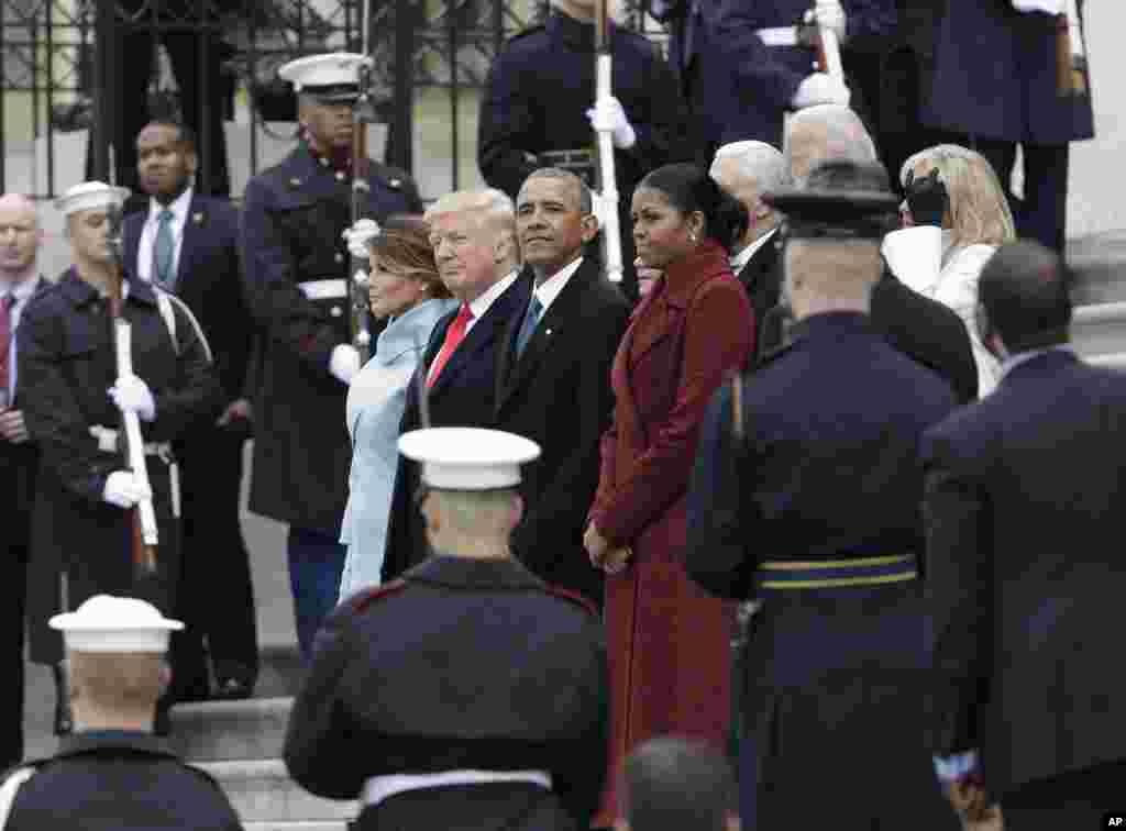 Former President Barack Obama and his wife Michelle stand with President Donald Trump and first lady Melania Trump during a departure ceremony on the East Front of the U.S. Capitol in Washington, Jan. 20, 2017, after Trump was inaugurated. 