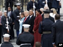 Former President Barack Obama and his wife Michelle stand with President Donald Trump and first lady Melania Trump during a departure ceremony on the East Front of the U.S. Capitol in Washington, Jan. 20, 2017, after Trump was inaugurated.