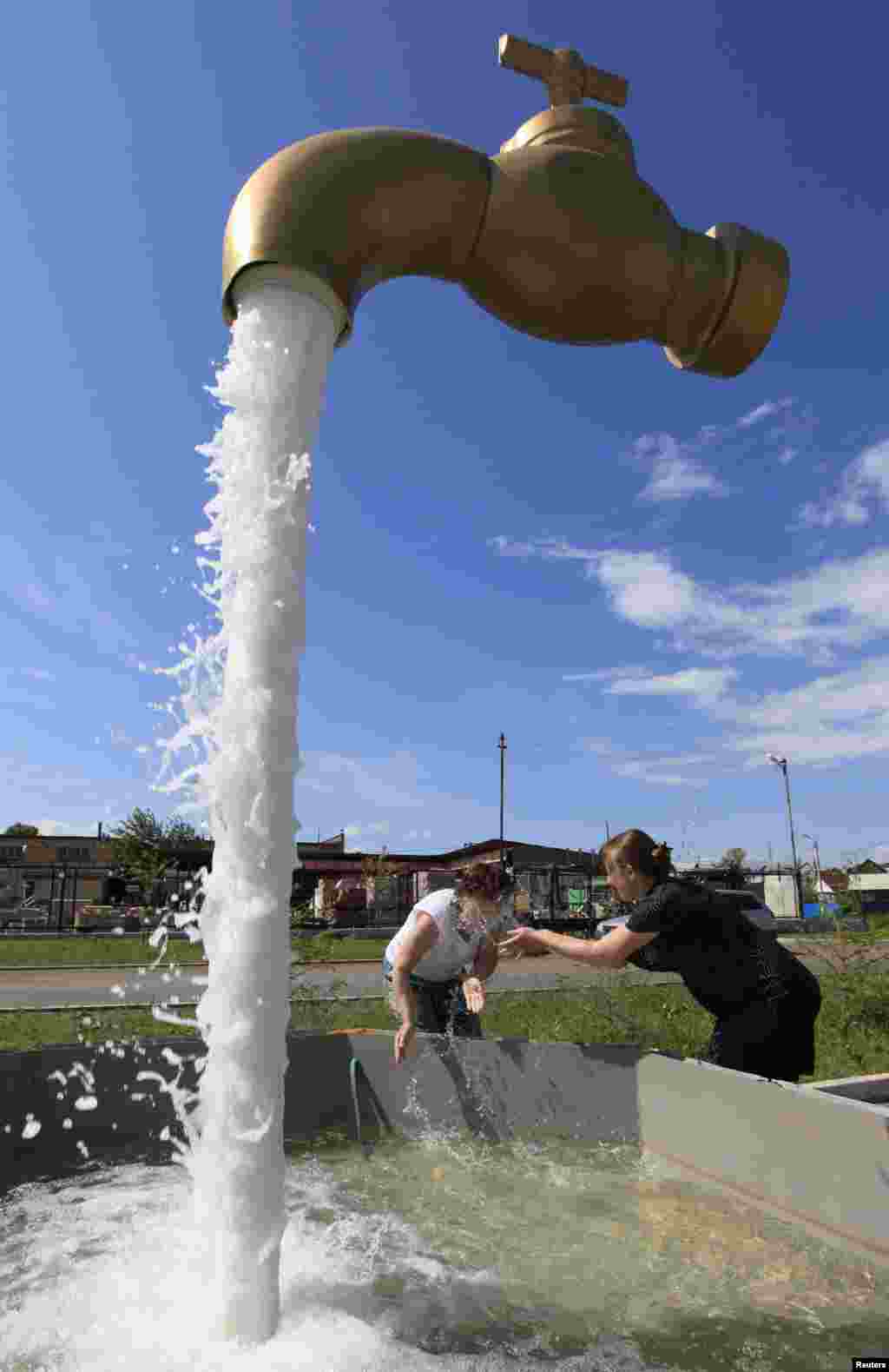 A fountain depicting a water tap is on display on the suburbs of Russia&#39;s Siberian city of Krasnoyarsk, July 9, 2013.