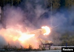 FILE - A Russian "TOS-1 Buratino" multiple rocket launcher fires during the "Russia Arms Expo 2013" 9th international exhibition of arms, military equipment and ammunition, in the Urals city of Nizhny Tagil. The U.S. and Russia’s weapons exports grew by 27 and 28 percent respectively during the period.