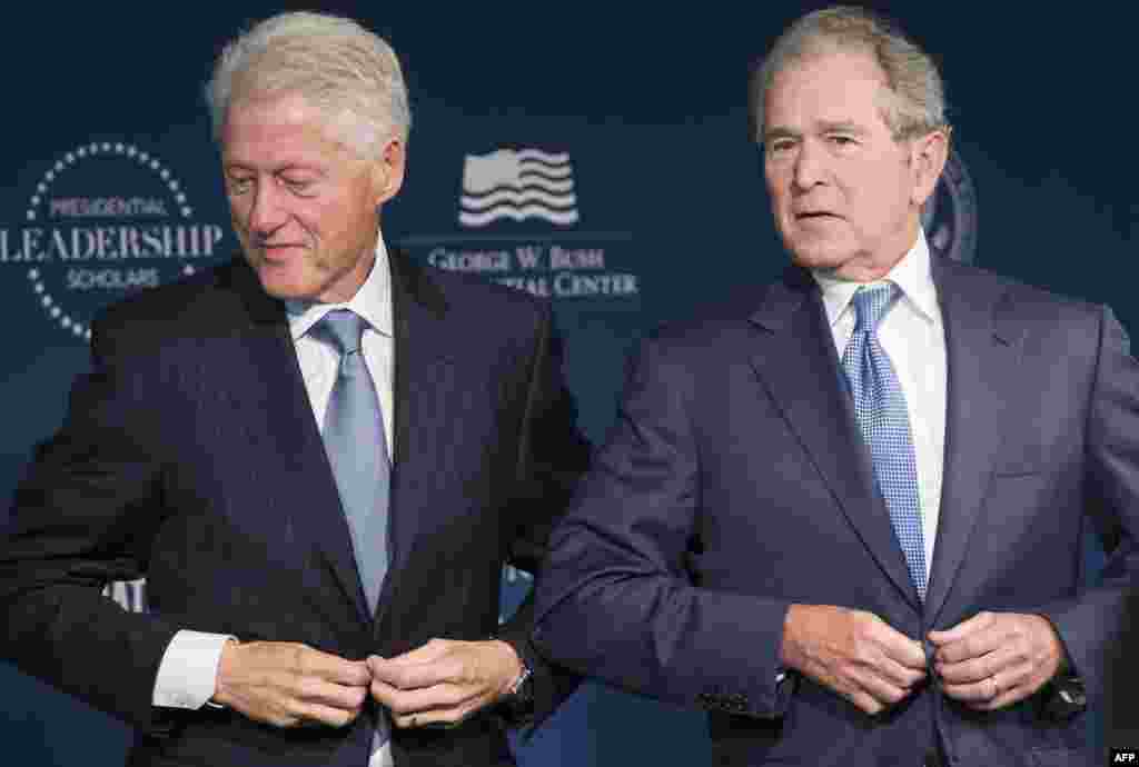 Former U.S. President Bill Clinton and President George W. Bush stand to leave after speaking during the launch of the Presidential Leadership Scholars Program at the Newseum in Washington, DC.