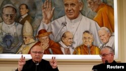 Chilean bishops Luis Fernando Ramos Perez and Juan Ignacio Gonzalez Errazuriz attend a news conference ahead of three days of closed-door crisis meetings with Pope Francis at the Vatican, May 14, 2018. 