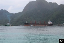 FILE - The North Korean cargo ship, Wise Honest, middle, was towed into the Port of Pago Pago, May 11, 2019, in Pago Pago, American Samoa.