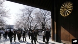 People view the blooming cherry blossoms at Yasukuni shrine in Tokyo, April 5, 2012.