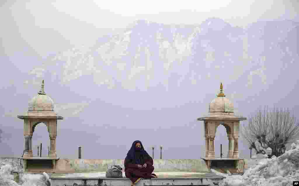 A Kashmiri Muslim woman prays outside Hazratbal Shrine after special prayers on the death anniversary of Abu Bakr Siddiq, the first Caliph of Islam, at Hazratbal Shrine in Srinagar, Indian-controlled Kashmir.