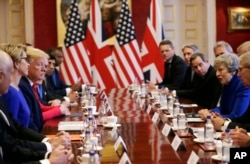 U.S President Donald Trump, center left, and British Prime Minister Theresa May, center right, attend a business roundtable event at St. James's Palace, London, Tuesday June 4, 2019.