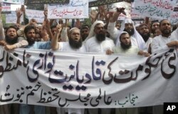 FILE - Pakistani Islamists protest the appointment of a minority Ahmadi Muslim as an adviser to the government, in Lahore, Pakistan, Sept. 7, 2018.
