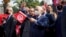 Leader of Tunisia's Islamist Ennahda party House Speaker Rached Ghannouchi waves a Tunisian flag during a rally in Tunis, Tunisia, Feb. 27, 2021. 