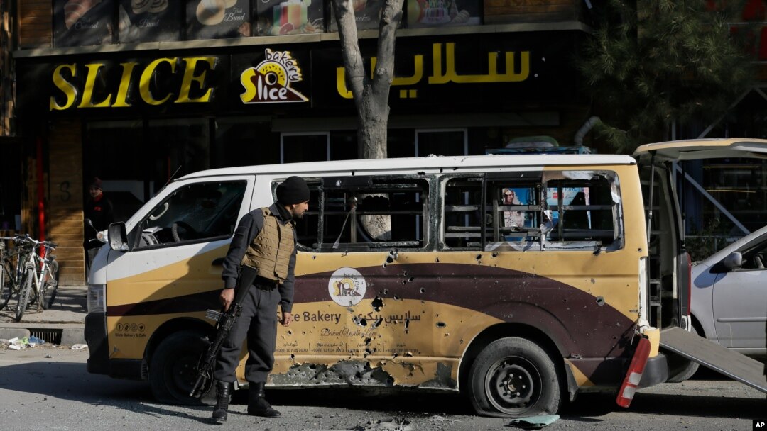 Afghan security checks a car destroyed in a rocket attack in Kabul, Afghanistan,Saturday, Nov. 21, 2020. Multiple rockets were fired around Kabul residential areas Saturday, killing several and wounding dozens of people. (AP Photo/Mariam Zuhaib)