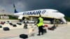 A Belarusian dog handler checks luggages off a Ryanair Boeing 737-8AS (flight number FR4978) parked on Minsk International Airport's apron in Minsk, on May 23, 2021. (ONLINER.BY / AFP)