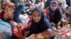 Ethnic Rohingya refugees sit at a temporary shelter in North Aceh, Indonesia, Nov. 15, 2022. 